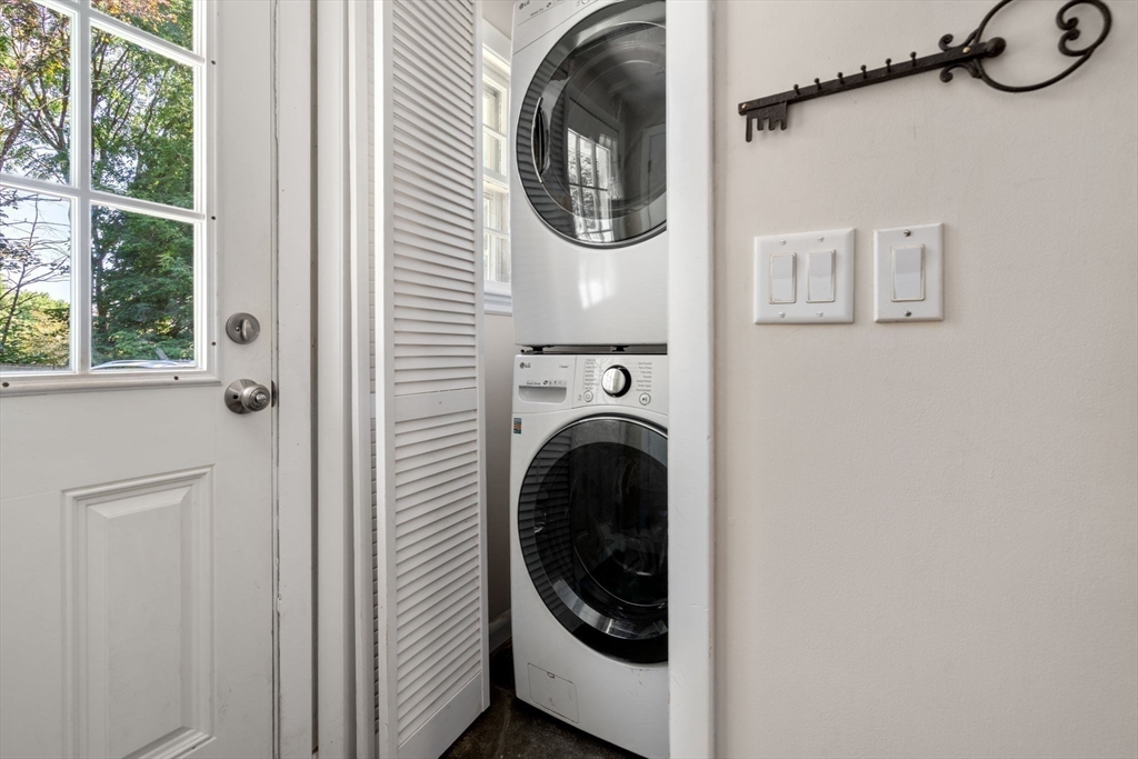 335 Conant Road Weston, MA 02493 - Photo 13 of 31 a view of a hallway with washer and dryer