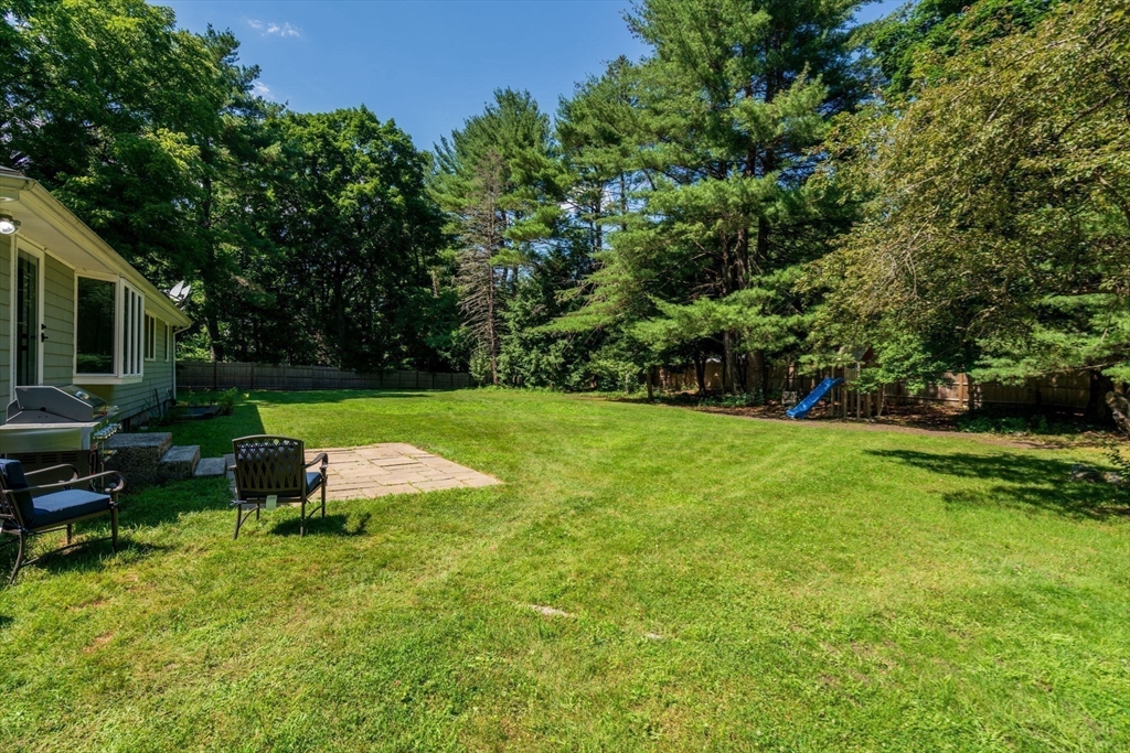 335 Conant Road Weston, MA 02493 - Photo 26 of 31 a view of a garden with lawn chairs
