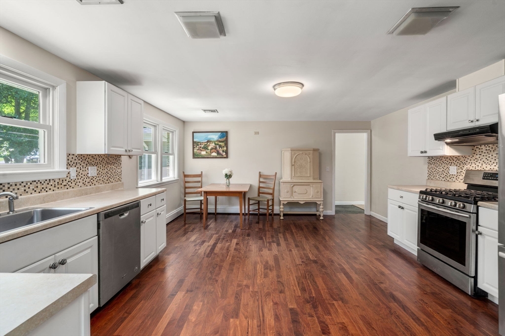 335 Conant Road Weston, MA 02493 - Photo 5 of 31 a kitchen with stainless steel appliances a stove sink and cabinets