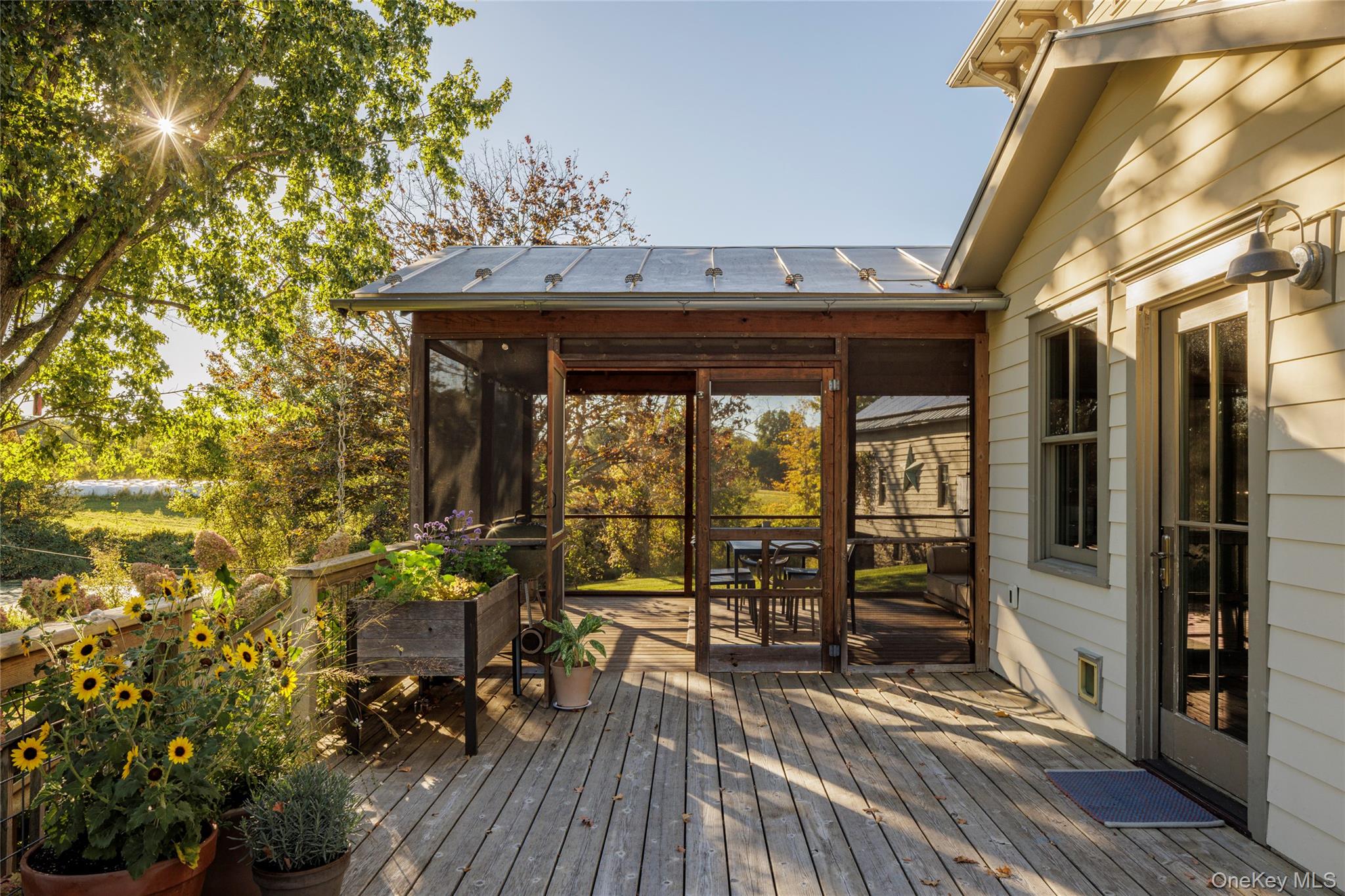 108 Wey Road Rhinebeck, NY 12572 - Photo 16 of 24 a view of a patio with table and chairs and potted plants