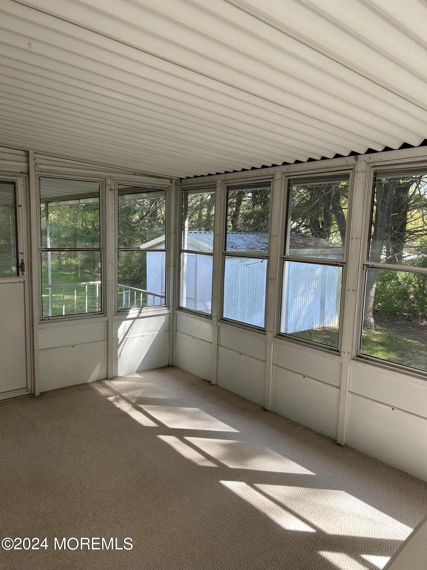 504 Rosalind Road Freehold, NJ 07728 - Photo 2 of 8 a view of an empty room with a balcony