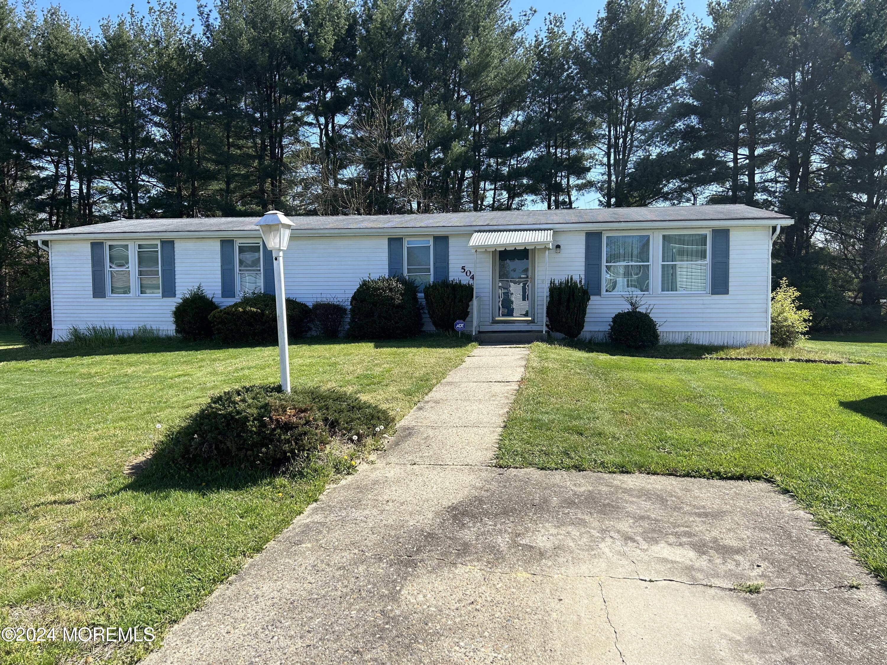 504 Rosalind Road Freehold, NJ 07728 - Photo 8 of 8 a front view of a house with garden and trees