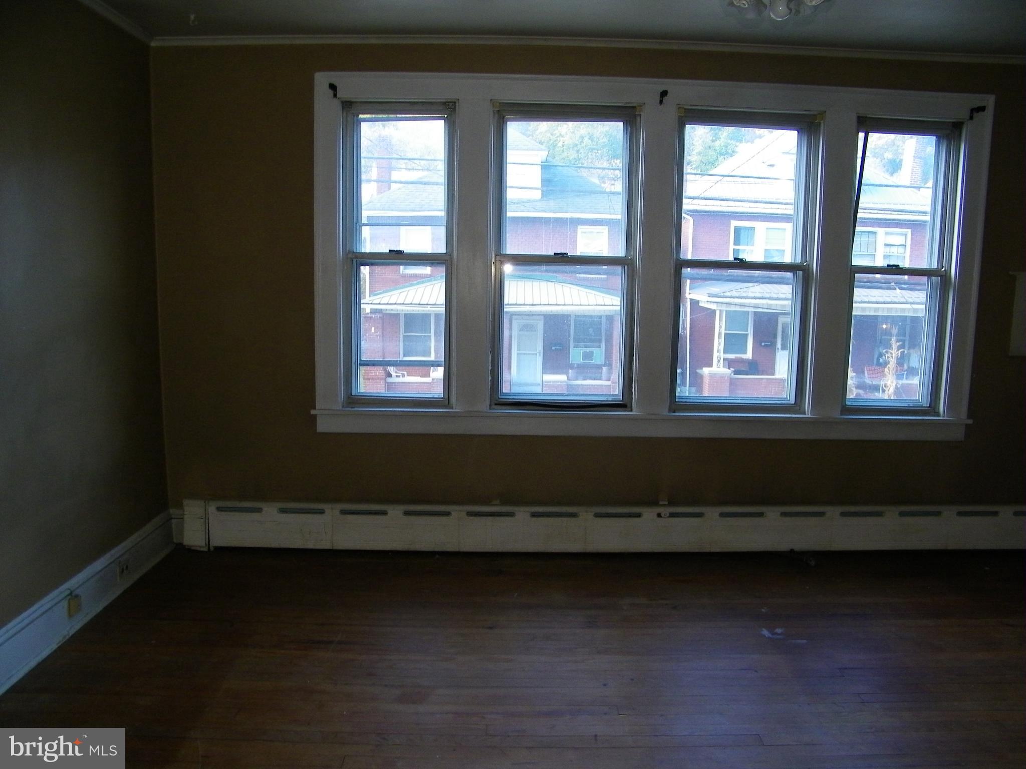 617 Frederick Street Cumberland, MD 21502 - Photo 11 of 16 a view of a room with wooden floor and windows