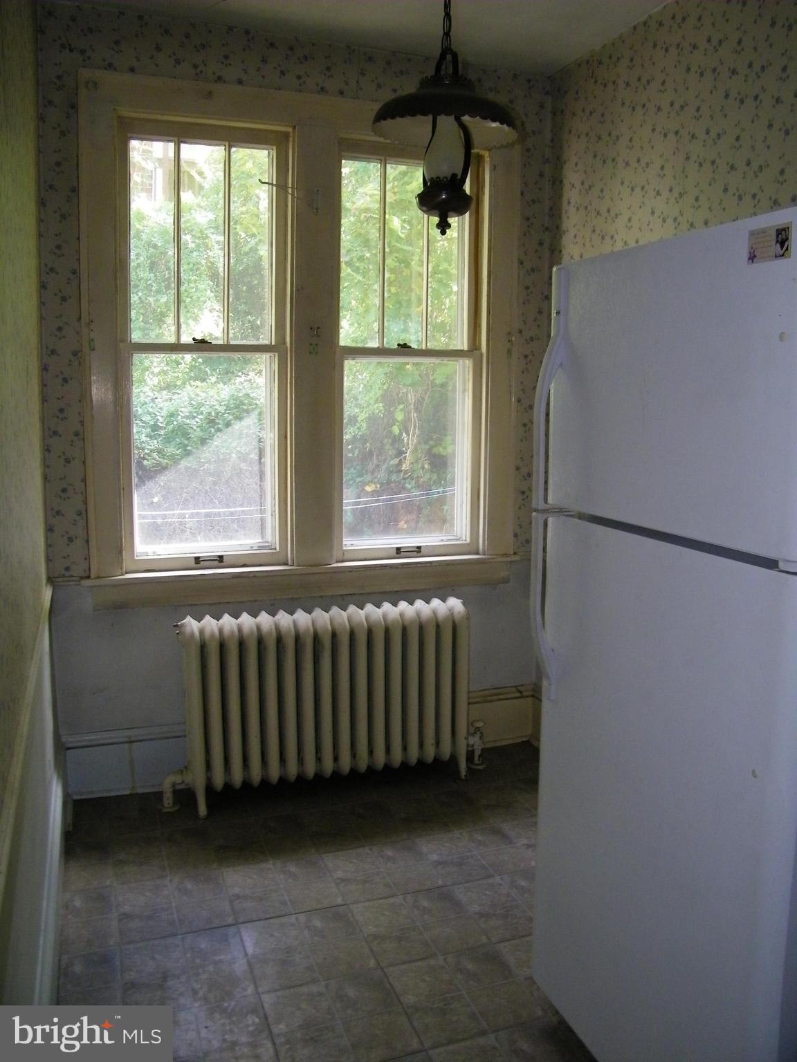 617 Frederick Street Cumberland, MD 21502 - Photo 10 of 16 a kitchen with a window and a refrigerator