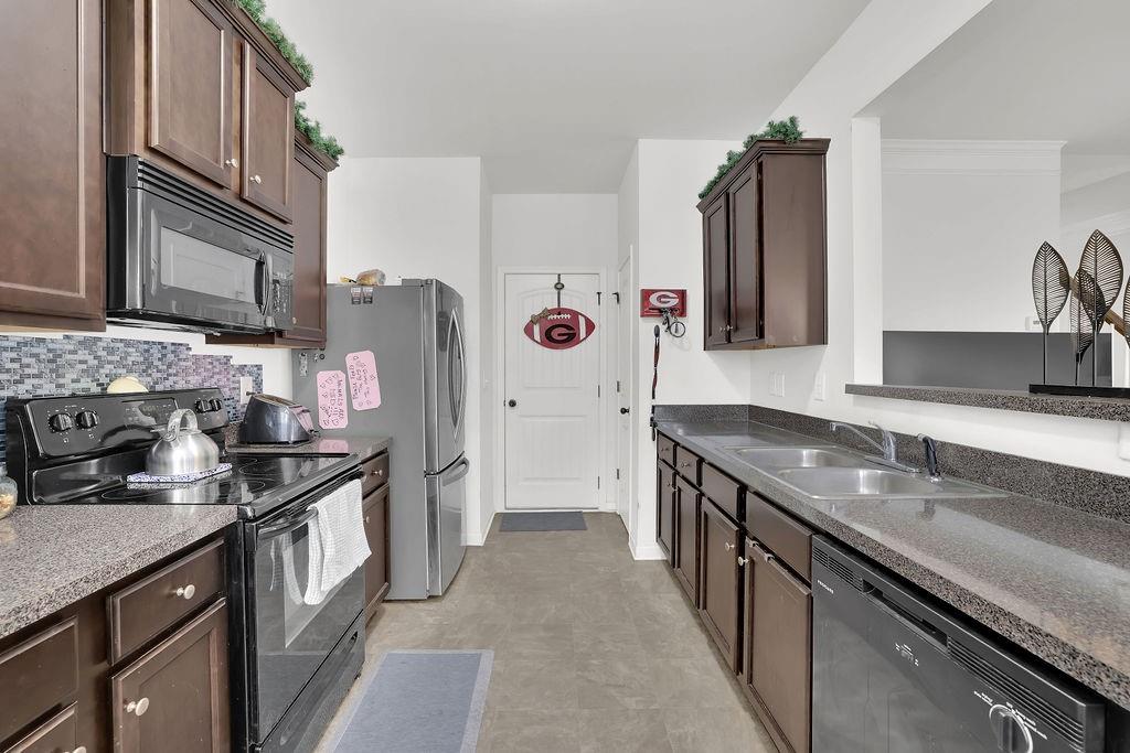 288 Valley Crossing Canton, GA 30114 - Photo 12 of 22 a kitchen with stainless steel appliances granite countertop a sink stove and refrigerator