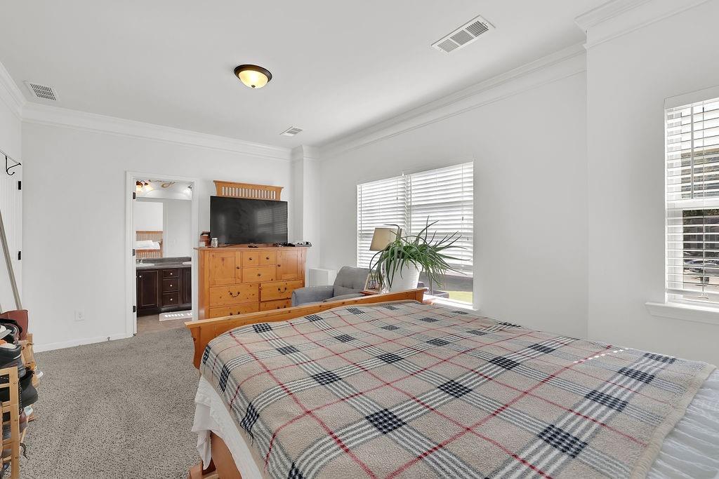 288 Valley Crossing Canton, GA 30114 - Photo 17 of 22 a bedroom with a large bed and flat tv screen on dresser
