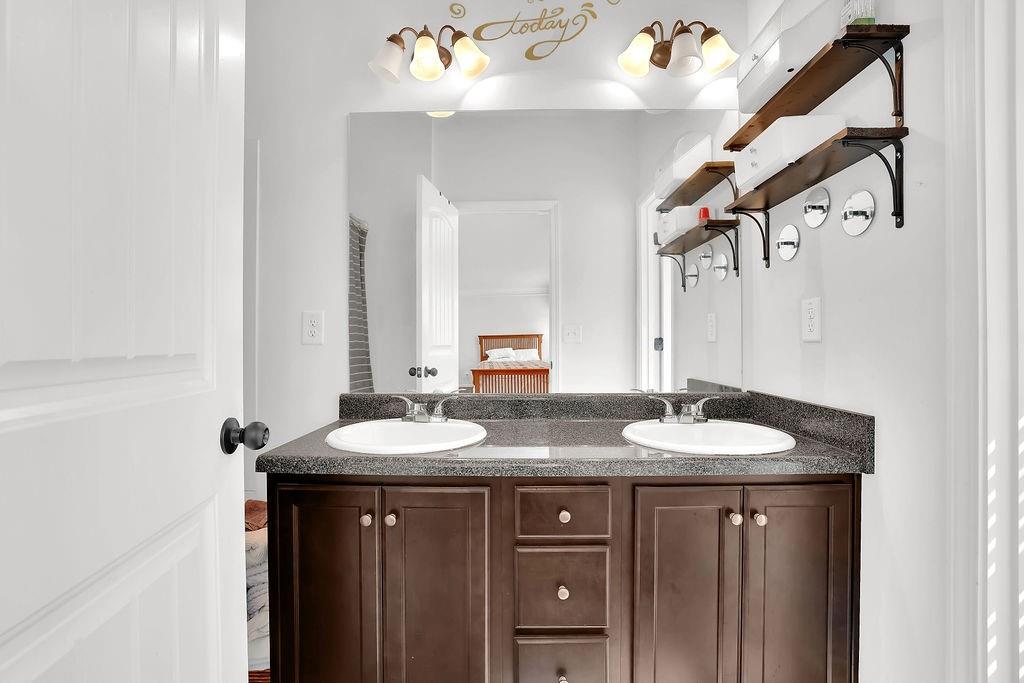 288 Valley Crossing Canton, GA 30114 - Photo 18 of 22 a bathroom with a granite countertop sink a mirror and a shower