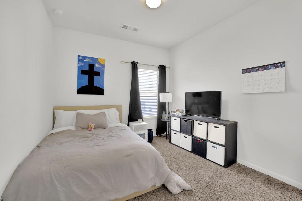 288 Valley Crossing Canton, GA 30114 - Photo 20 of 22 a bedroom with a bed and a flat screen tv