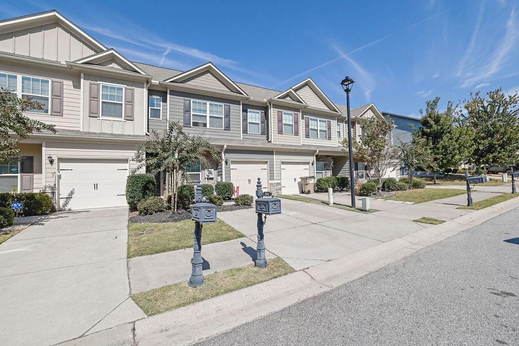 288 Valley Crossing Canton, GA 30114 - Photo 3 of 22 a front view of a house with a garden