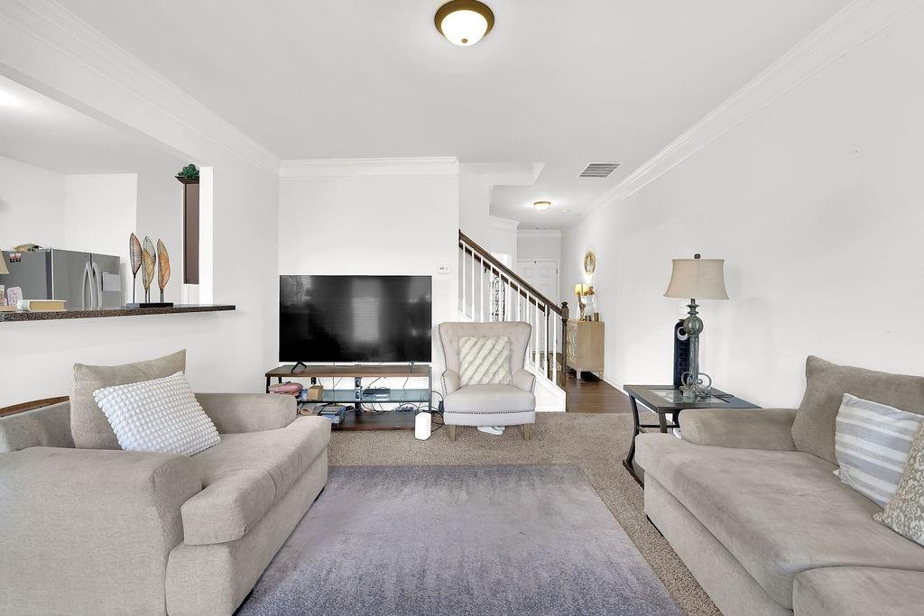 288 Valley Crossing Canton, GA 30114 - Photo 7 of 22 a living room with furniture and a flat screen tv
