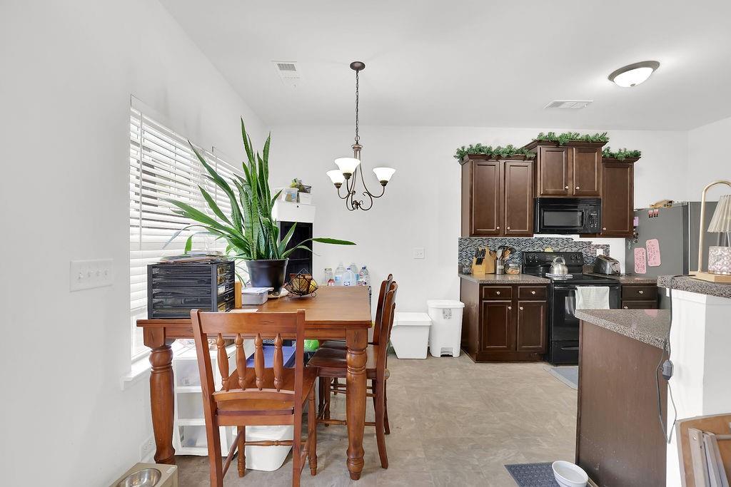 288 Valley Crossing Canton, GA 30114 - Photo 9 of 22 a dining room filled chandelier and wooden floor