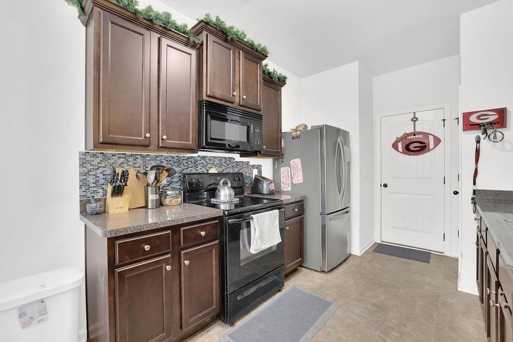 288 Valley Crossing Canton, GA 30114 - Photo 10 of 22 a kitchen with stainless steel appliances granite countertop a refrigerator stove and sink
