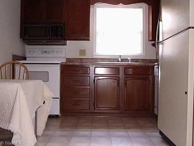 4839 Tower Road, Unit B Greensboro, NC 27410 - Photo 6 of 9 Other. Kitchen with builtin microwave, dishwasher, free standing range and refrigerator, new light fixtures, counter tops and vinyl.