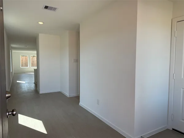a view of hallway with bathroom