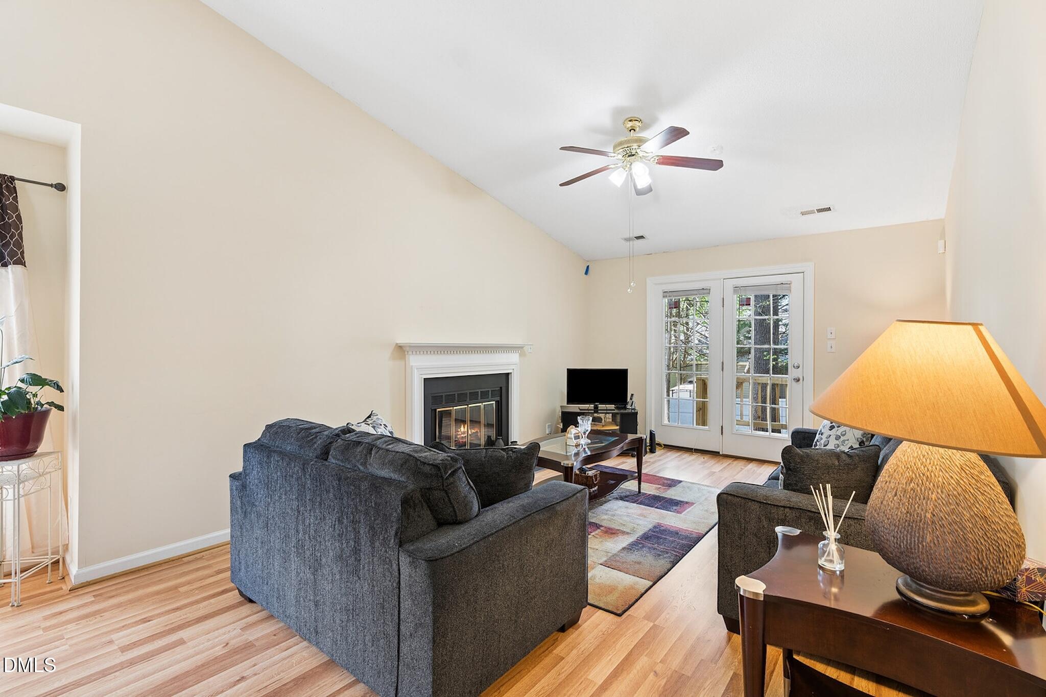 4365 Bona Court Raleigh, NC 27604 - Photo 11 of 29 a living room with furniture a fireplace and a flat screen tv
