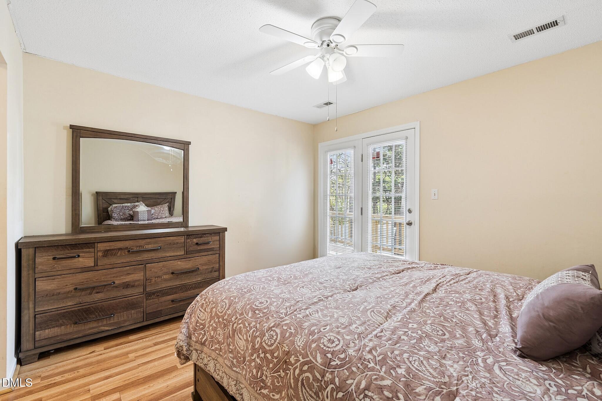 4365 Bona Court Raleigh, NC 27604 - Photo 17 of 29 a bedroom with a large bed and a dresser
