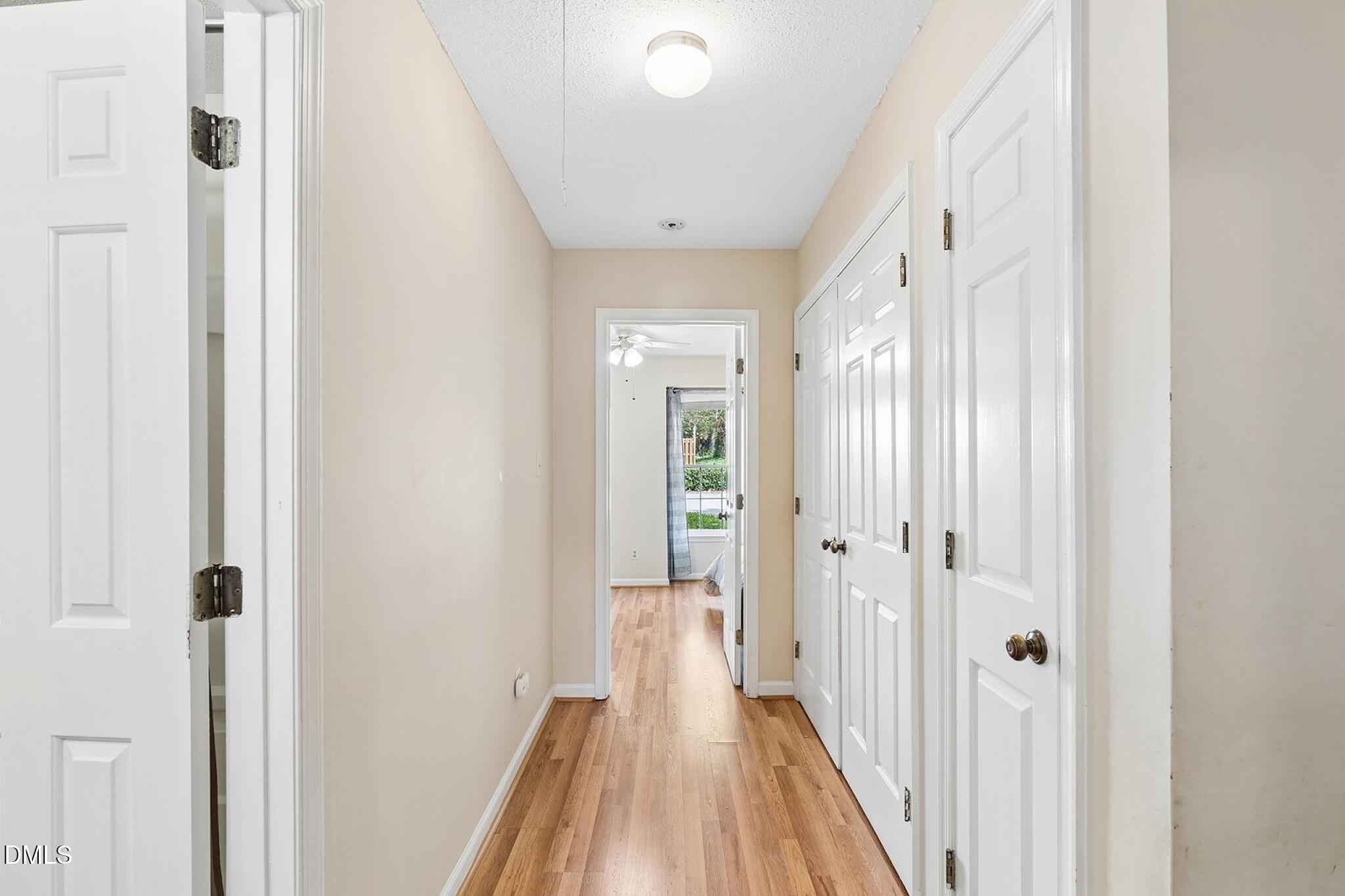4365 Bona Court Raleigh, NC 27604 - Photo 20 of 29 a view of a hallway with wooden floor and a bathroom