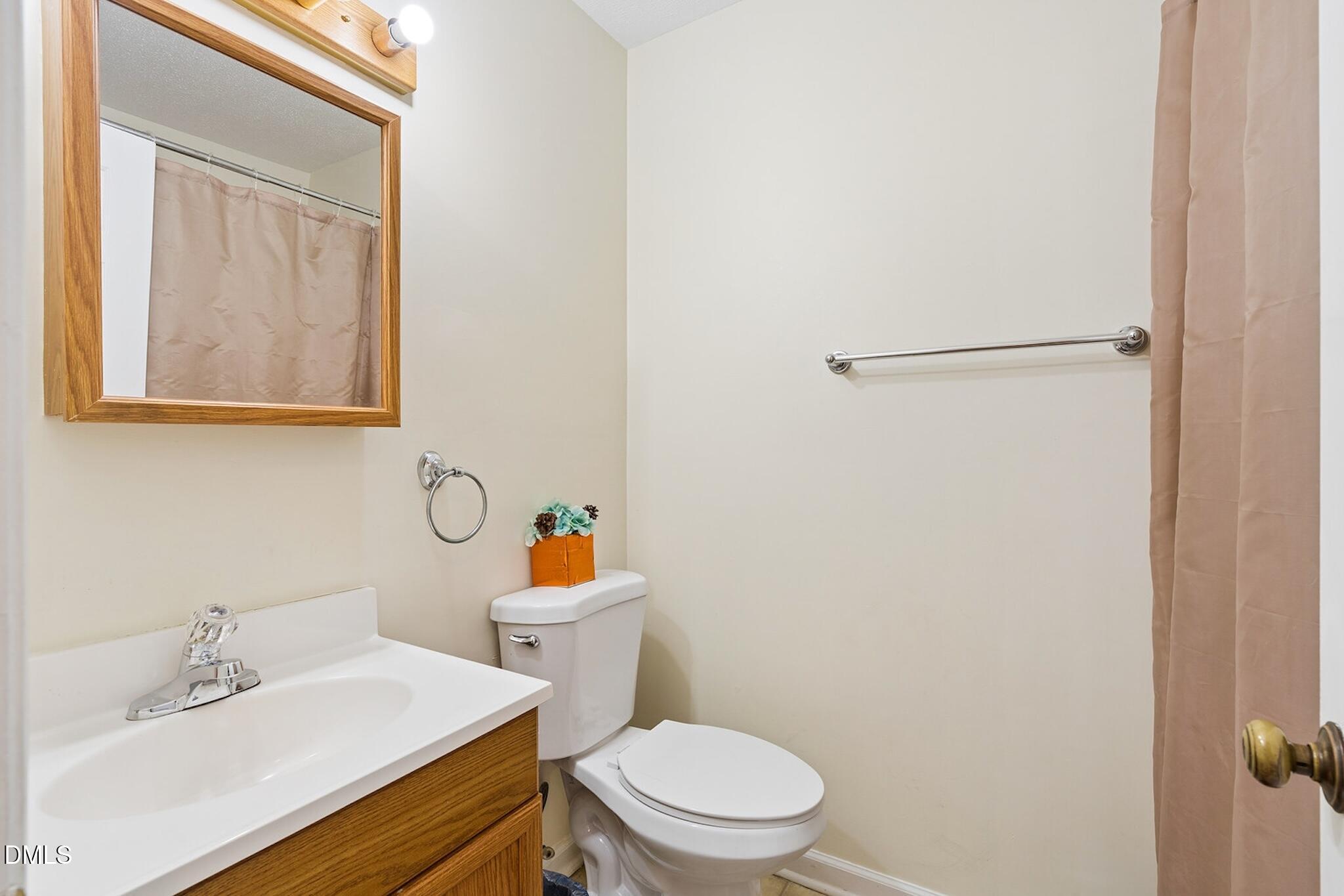 4365 Bona Court Raleigh, NC 27604 - Photo 23 of 29 a white toilet sitting next to a bathroom sink