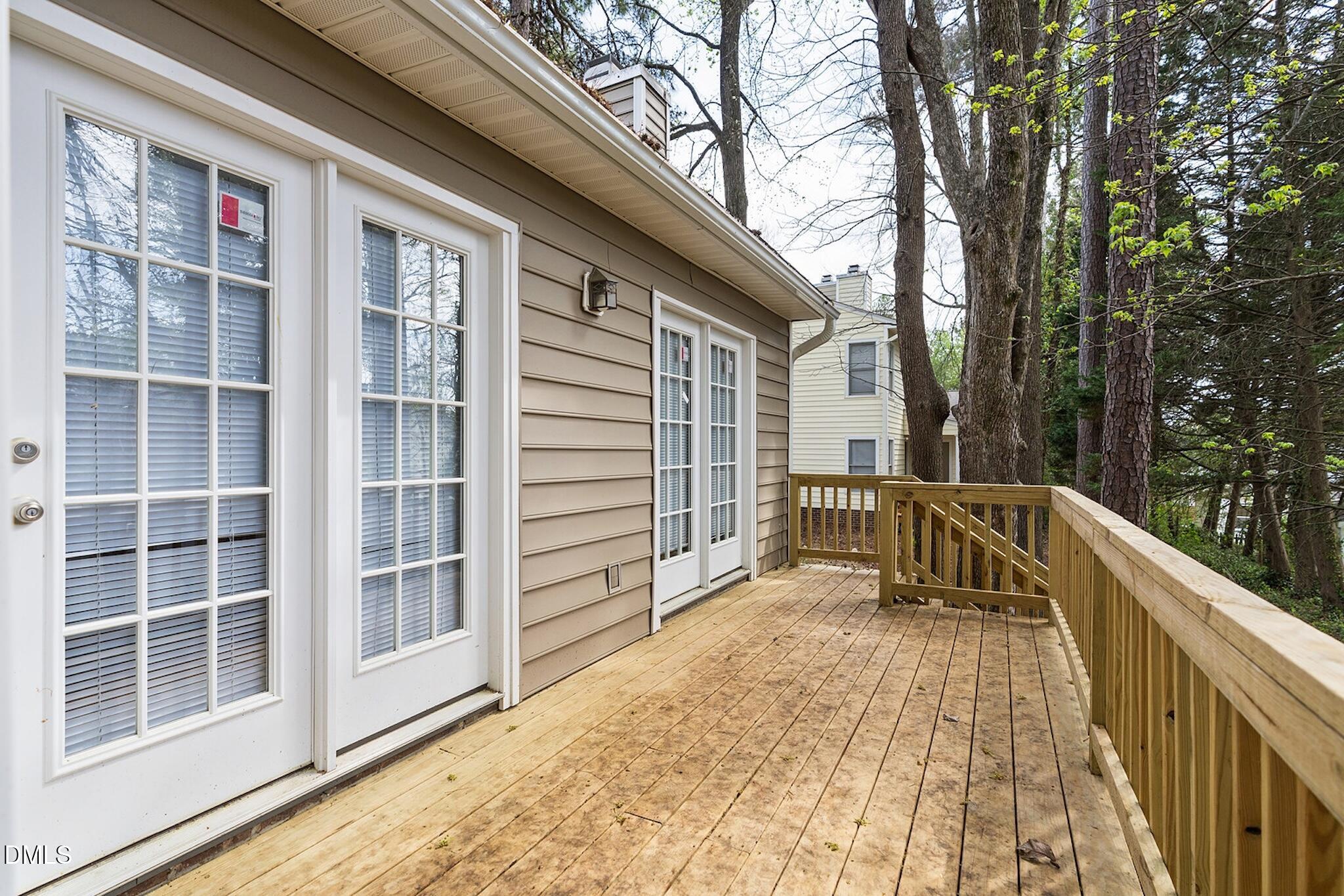 4365 Bona Court Raleigh, NC 27604 - Photo 25 of 29 a view of balcony with a large window and wooden fence