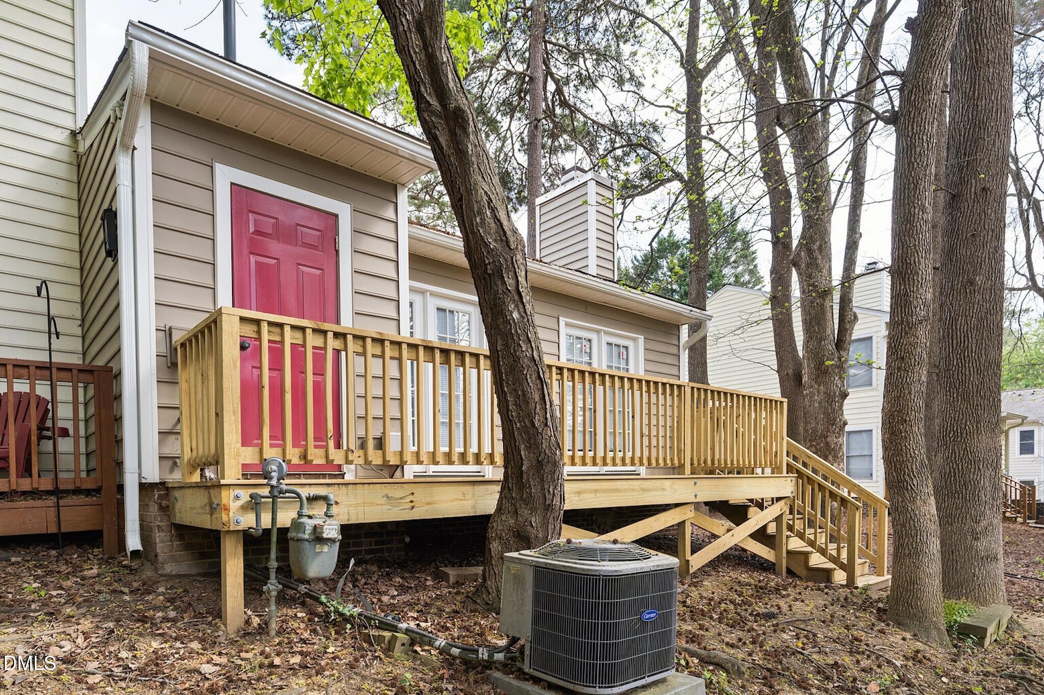 4365 Bona Court Raleigh, NC 27604 - Photo 27 of 29 a view of a patio with table and chairs and wooden fence