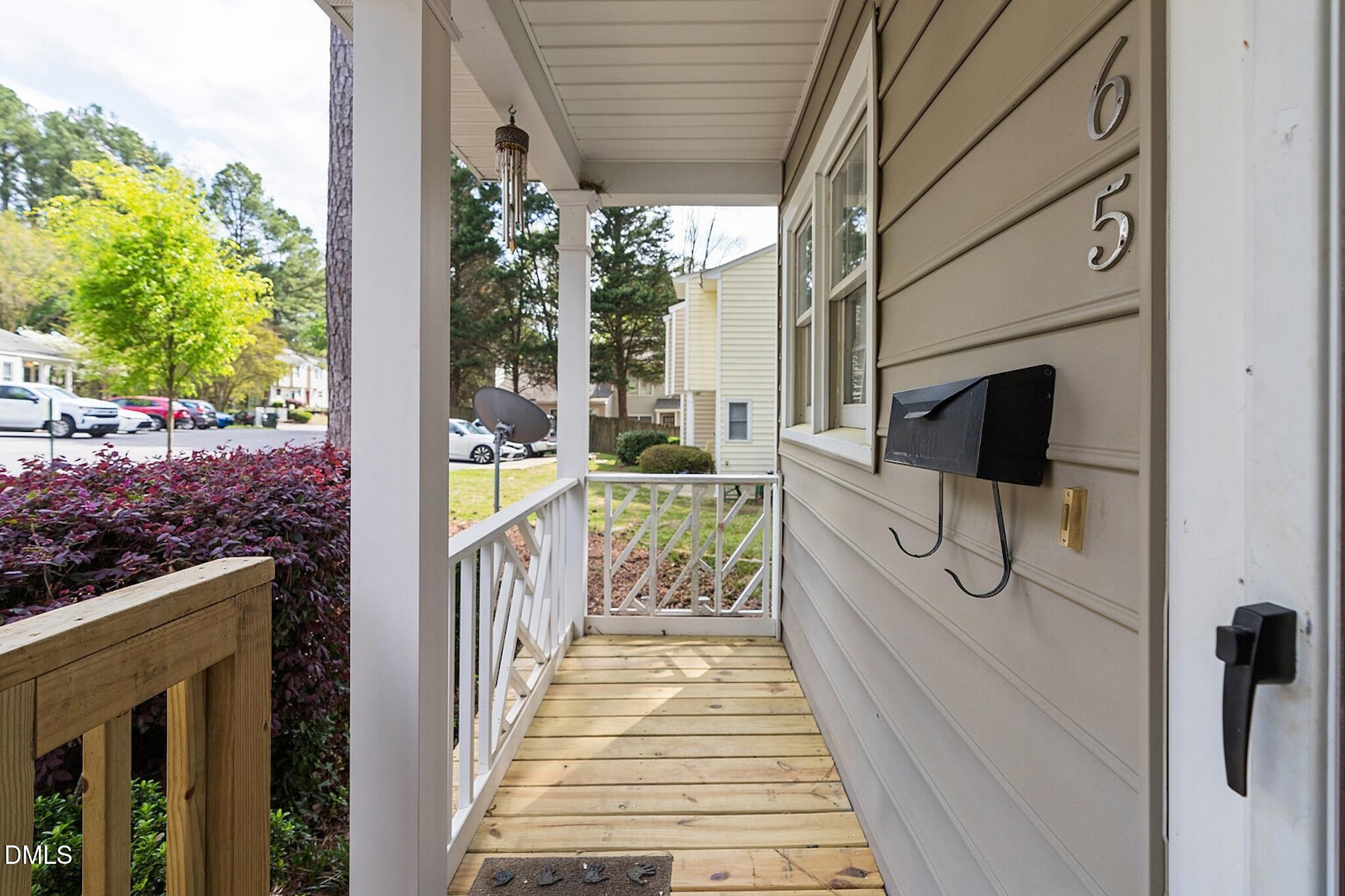 4365 Bona Court Raleigh, NC 27604 - Photo 3 of 29 a view of a porch with wooden floor and iron fence