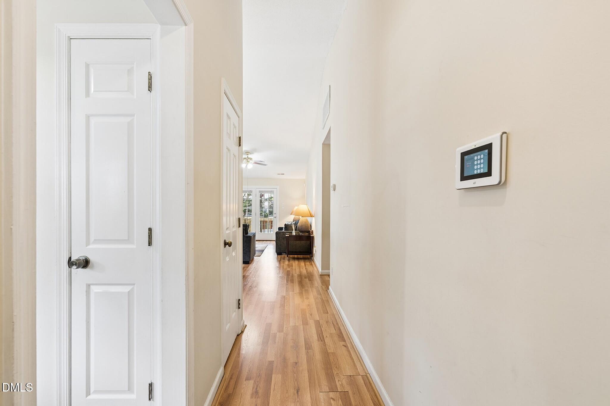 4365 Bona Court Raleigh, NC 27604 - Photo 4 of 29 a view of a hallway with wooden floor and a bathroom