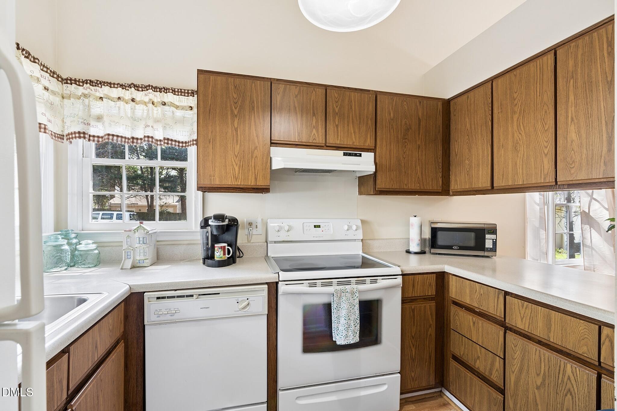 4365 Bona Court Raleigh, NC 27604 - Photo 5 of 29 a kitchen with stainless steel appliances a stove a sink a refrigerator and cabinets