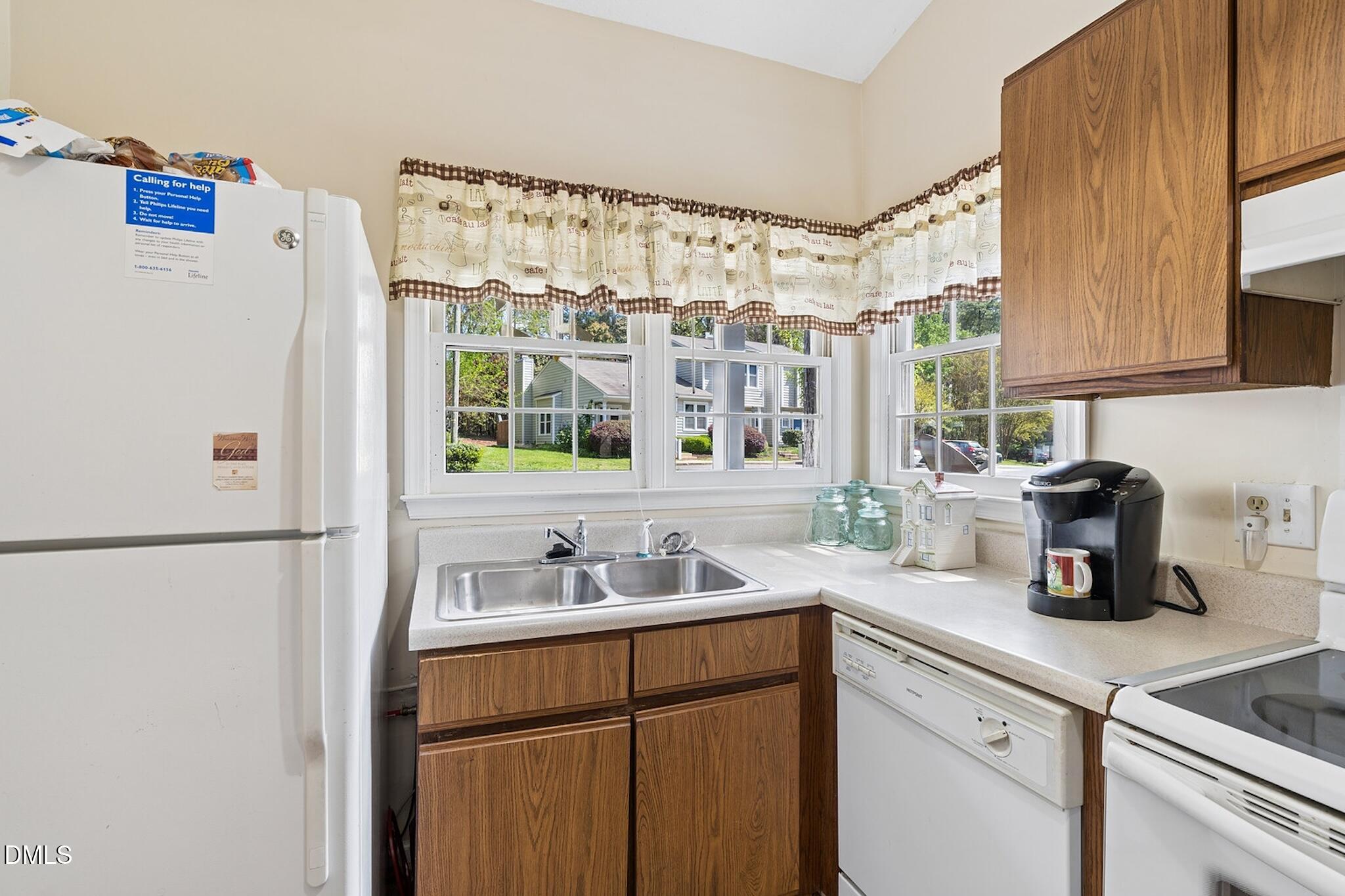 4365 Bona Court Raleigh, NC 27604 - Photo 6 of 29 a kitchen with a refrigerator and a sink