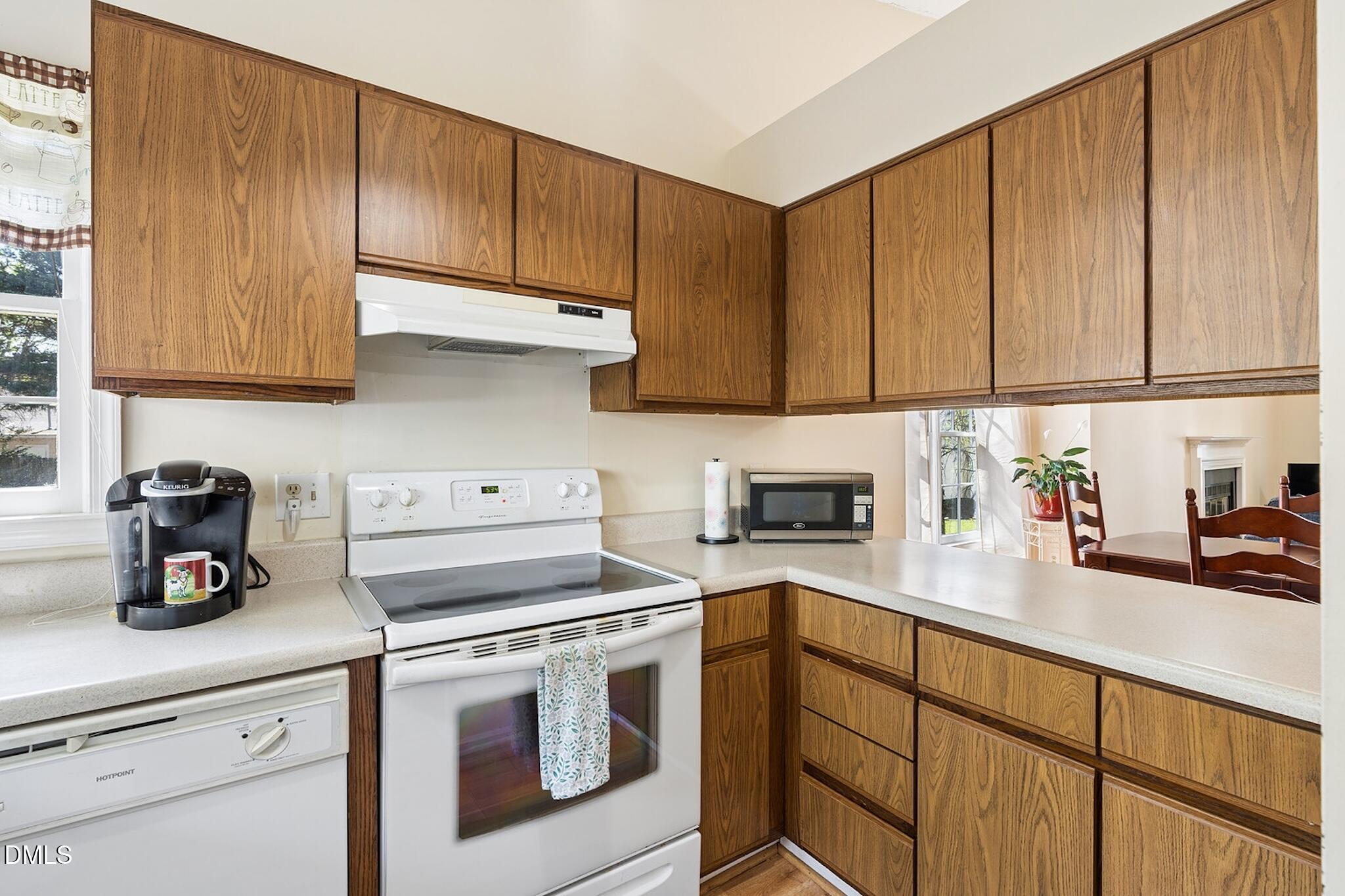 4365 Bona Court Raleigh, NC 27604 - Photo 7 of 29 a kitchen with stainless steel appliances granite countertop a sink a stove and cabinets