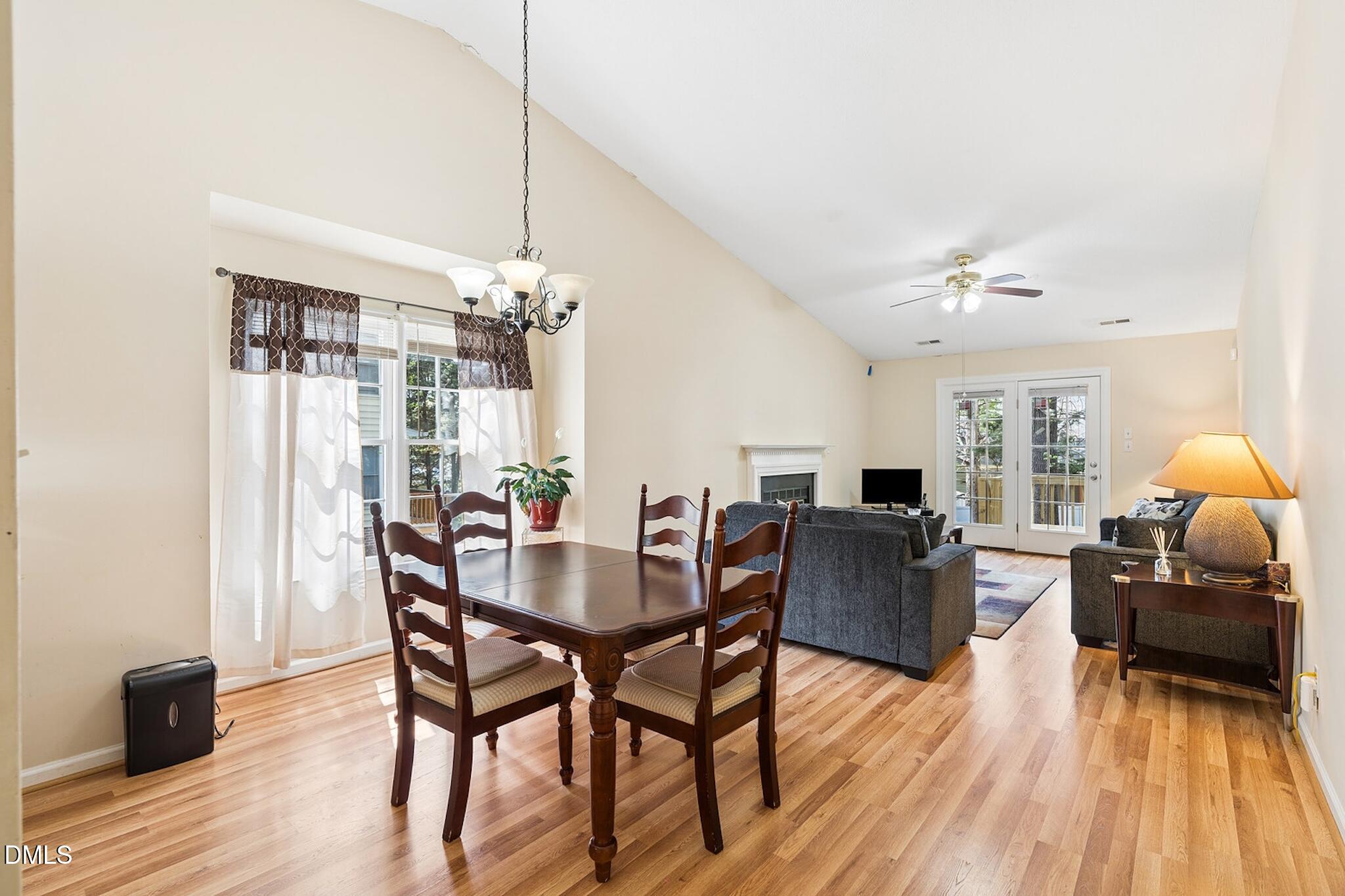 4365 Bona Court Raleigh, NC 27604 - Photo 8 of 29 a living room with furniture a dining table and a chandelier