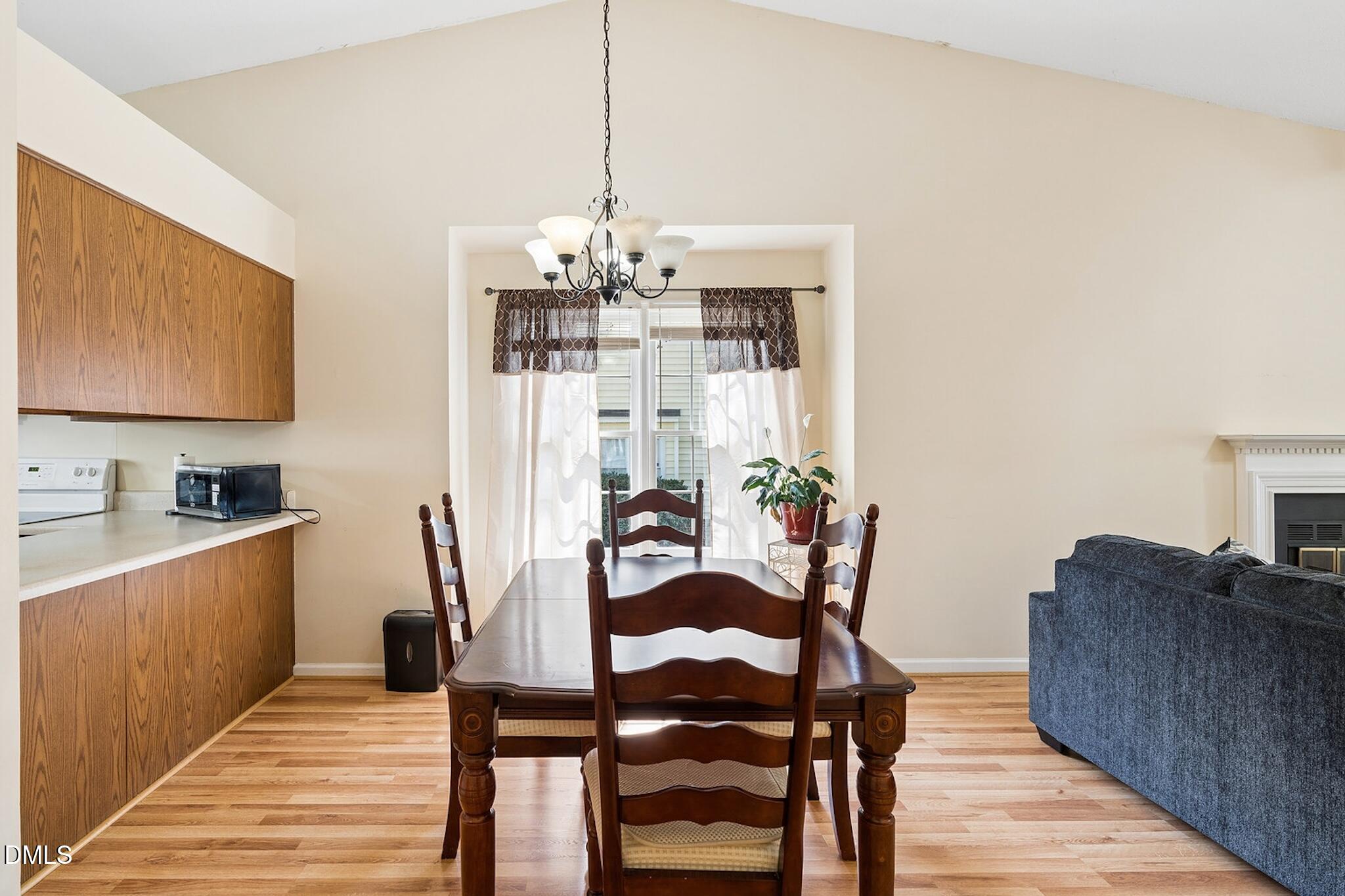 4365 Bona Court Raleigh, NC 27604 - Photo 9 of 29 a view of a dining room with furniture wooden floor and a chandelier