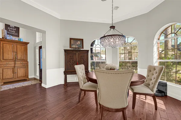 a dining room with furniture a chandelier and window
