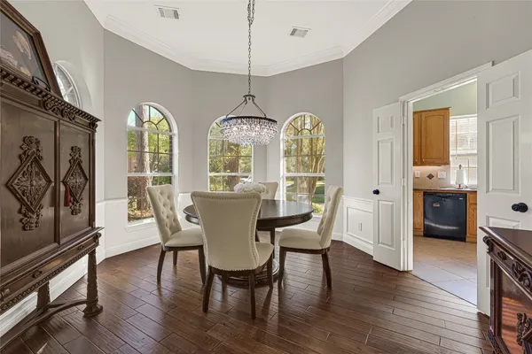 a bedroom with a bed mirror and a large window