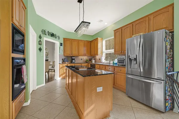 a bedroom with a bed and a flat tv screen on dresser