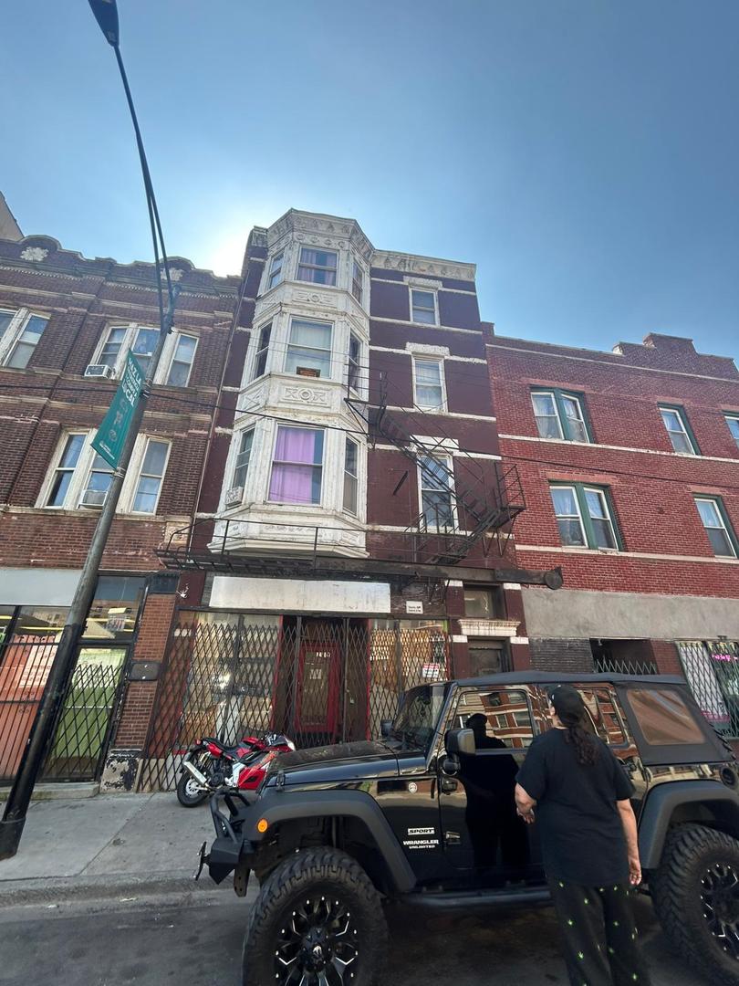 3011 West Cermak Road Chicago, IL 60623 - Photo 2 of 2 a front view of a building and car parked