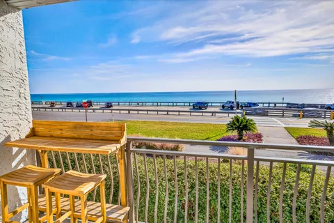 a view of swimming pool with outdoor seating and city view