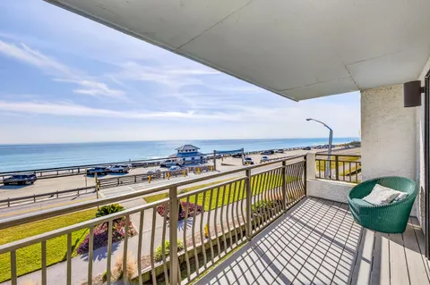 a balcony with a table and chairs