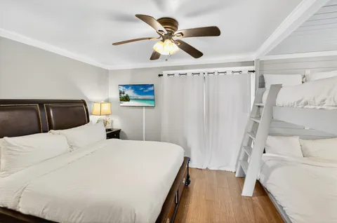 a bedroom with a bed and a ceiling fan