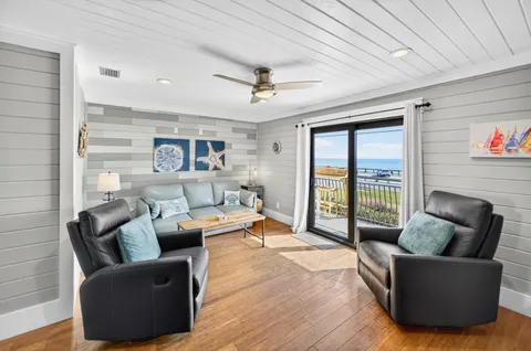 a living room with furniture and a floor to ceiling window