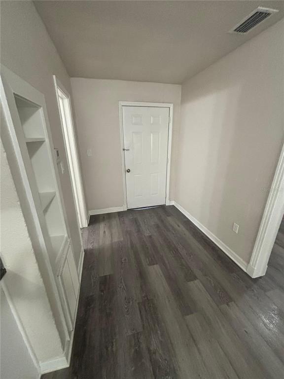200 Magnolia Street Altamonte Springs, FL 32701 - Photo 3 of 6 wooden floor in an empty room with a window