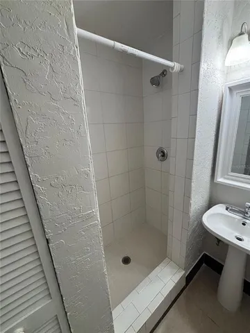 a bathroom with a shower and sink