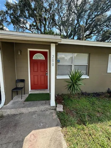 a couple of potted plants in front of door