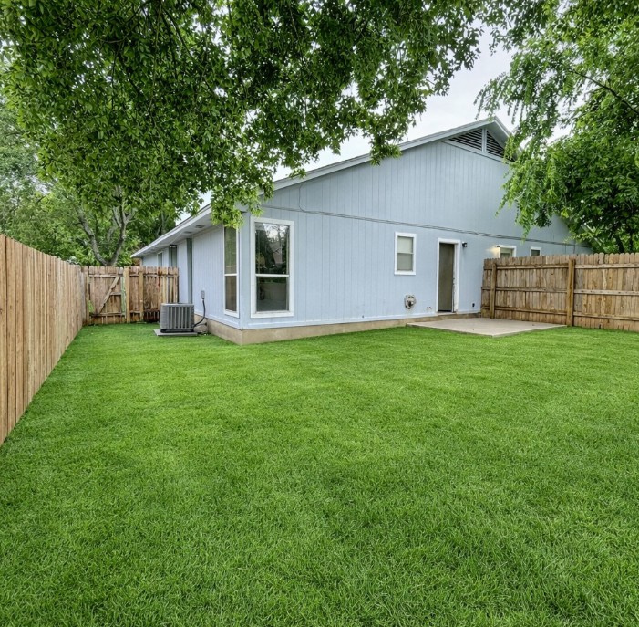 2114 Redwing Way Round Rock, TX 78664 - Photo 8 of 8 Rear view of house featuring a fenced backyard and a patio
