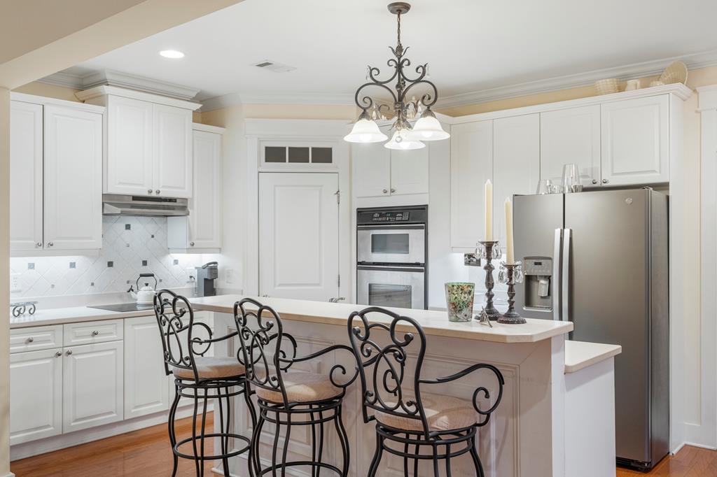 202 White Oak Road Pine Mountain, GA 31822 - Photo 26 of 70 a kitchen with stainless steel appliances granite countertop a dining table chairs refrigerator and cabinets