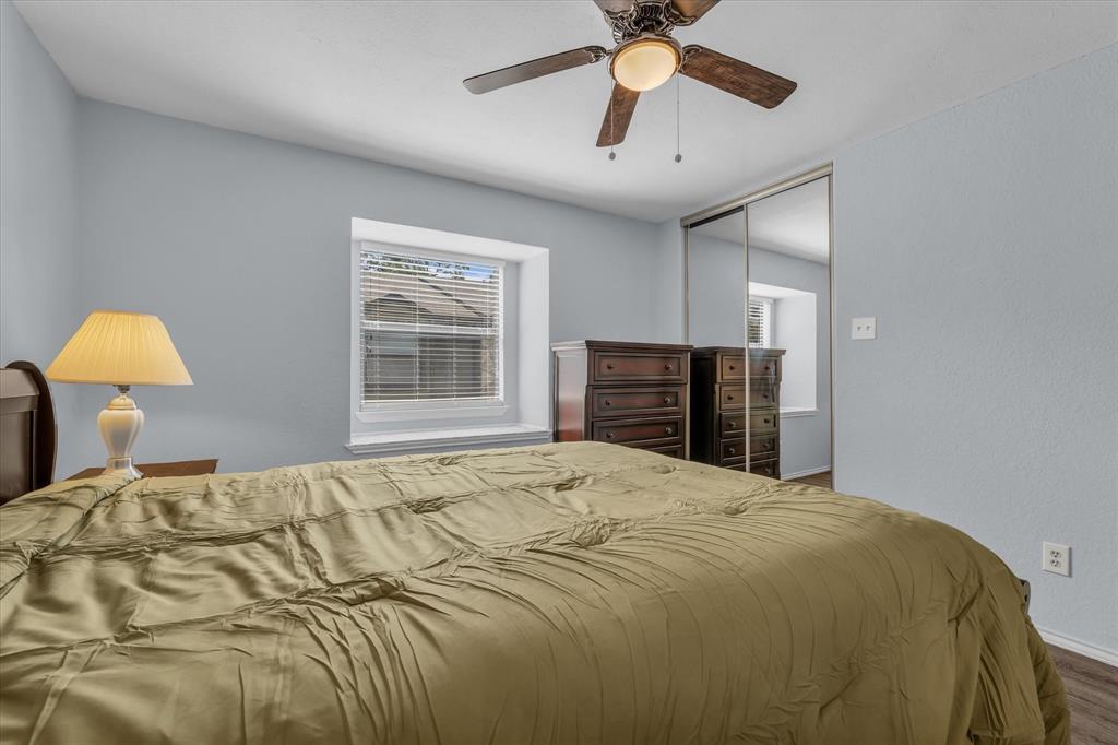 1365 South 11th Street Waco, TX 76706 - Photo 13 of 21 a bedroom with a bed and dresser with chandelier