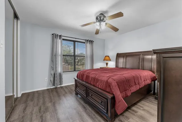 a spacious bedroom with a bed and a chandelier