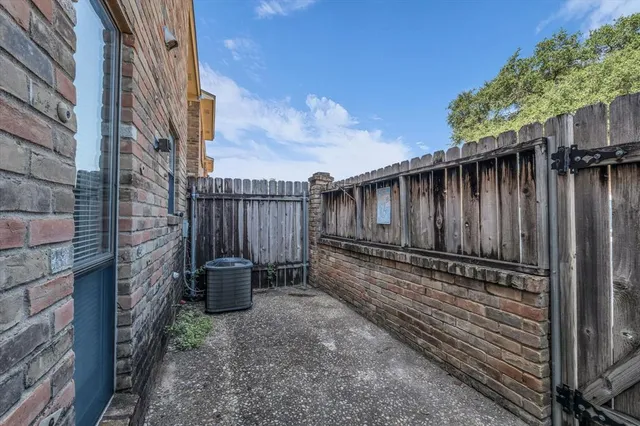 a backyard of a house with chairs