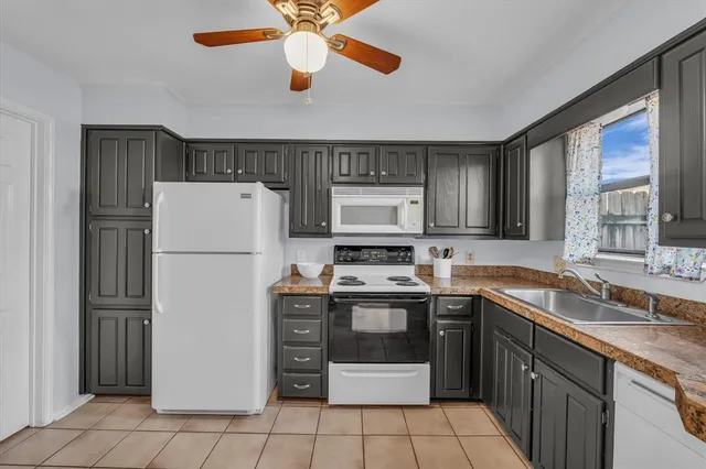 a kitchen with stainless steel appliances granite countertop a refrigerator sink and cabinets