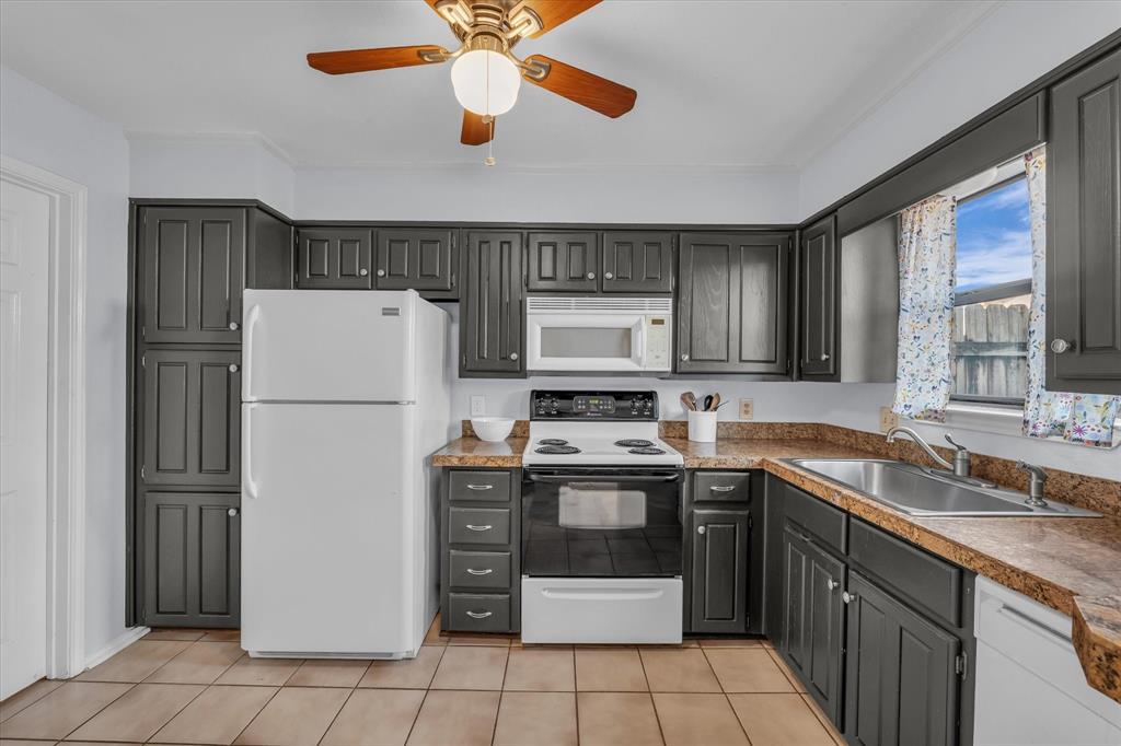 1365 South 11th Street Waco, TX 76706 - Photo 6 of 21 a kitchen with stainless steel appliances granite countertop a refrigerator sink and cabinets