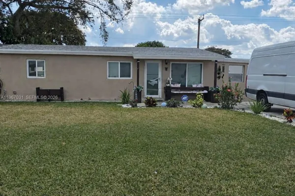 a front view of house with yard having outdoor seating